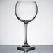 A Chef & Sommelier clear wine glass with a long stem on a table.