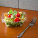 A salad in a Dart ClearPac rectangular plastic container with a fork.