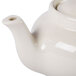 A Hall China ivory teapot with a lid.
