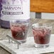 A marble tray with two glasses of Narvon grape soda with ice.