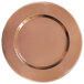 A close up of a round copper charger plate with a beaded rim.