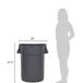 A large grey Continental Huskee trash can with a woman standing in front of it.