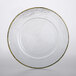 A clear glass plate with a gold weave rim.