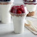 A 12 oz PET parfait cup filled with yogurt and raspberries.