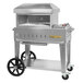A silver Crown Verity mobile outdoor pizza oven on wheels.