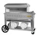 A large stainless steel Crown Verity outdoor pizza oven on wheels with a silver border.