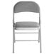 A Lancaster Table & Seating grey fabric folding chair with a padded seat.
