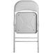 The back of a gray Lancaster Table & Seating folding chair with a padded seat.