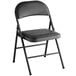 A Lancaster Table & Seating black vinyl folding chair with a black padded seat.