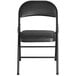 A black Lancaster Table & Seating folding chair with a black cushion.