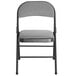 A dark grey folding chair with a padded seat.