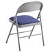 A Lancaster Table & Seating blue fabric folding chair with a padded blue cushion.