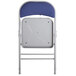 A back view of a Lancaster Table & Seating blue fabric folding chair with a padded seat.
