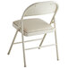 A beige folding chair with a padded seat.