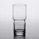 A close up of a clear Libbey stackable beverage glass with a drink in it.