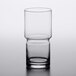 A close-up of a clear Libbey stackable beverage glass with a half empty rim.
