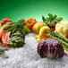 A group of vegetables on ice including a close-up of a carrot.