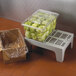 A plastic container of lettuce on a Cambro bow tie dunnage rack.