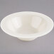 A Homer Laughlin ivory china bowl with a small rim on a white background.