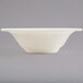 A close up of a Homer Laughlin ivory china grapefruit bowl on a white background.