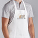 A man wearing a white Choice customizable apron with 3 pockets.