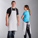 A man and woman wearing Choice white aprons.