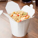 A SmartServ white microwavable paper take-out container with noodles and vegetables.
