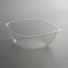 A clear Fineline PET plastic bowl with a curved edge on a table.