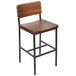 A BFM Seating Memphis counter height stool with a wooden seat and backrest on metal legs.