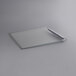 A white rectangular glass lid with a metal handle.