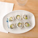 A table set with a Thunder Group Blue Bamboo melamine tray with sushi rolls.