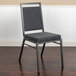 A Flash Furniture dark grey fabric banquet chair with a silver frame.