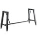 A black metal Lancaster Table & Seating trestle table base with long metal legs.