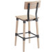 A Lancaster Table & Seating rustic industrial bar height chair with a white wash finish and a black metal frame.