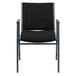 A Flash Furniture black fabric stack chair with arms and a metal frame with grey accents.
