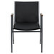 A Flash Furniture black vinyl stack chair with arms.
