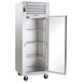 A Traulsen G Series reach-in refrigerator with a right-hinged glass door open on a white background.