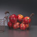 A wire basket with a red apple in it.