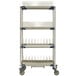 A MetroMax i mobile four tier tray and steam pan drying rack with drip tray on wheels.