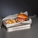 A Libbey stainless steel square fry presentation basket with a burger and fries inside.