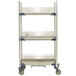 A white MetroMax metal three tier tray drying rack with wheels.