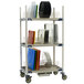A MetroMax metal three tier tray drying rack with dishes on it.