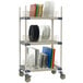 A MetroMax 4 three tier mobile tray drying rack with plates on it.