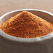 A bowl of Regal Cajun Spice on a table.