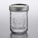 A Ball wide mouth glass canning jar with a silver lid.