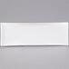 A white rectangular porcelain serving platter with a curved edge on a gray background.