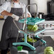 A man using a Prince Castle lettuce chopper on a counter in a professional kitchen.