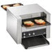 A Vollrath convertible conveyor toaster with a sandwich being cooked inside.