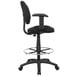 A black Boss drafting stool with black armrests and a chrome footring.