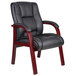 A Boss black leather mid back guest chair with mahogany wooden legs.